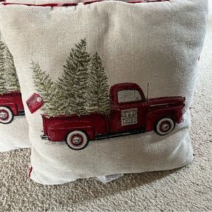Two 19 inch Christmas pillows with red truck on one side and red plaid